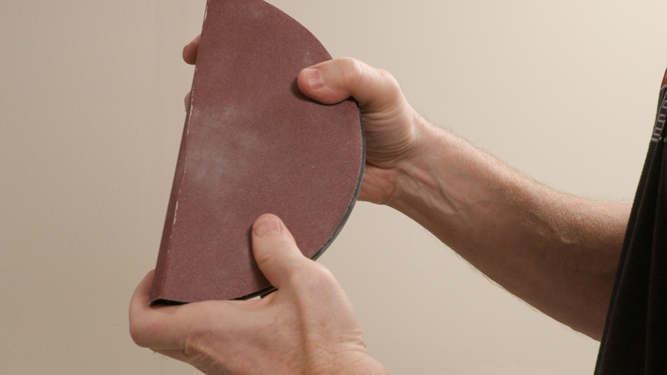 reattaching the sandpaper to the folding radial sander head